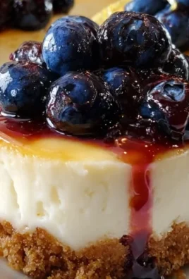 Healthy mini lemon blueberry cheesecakes topped with fresh berries.