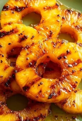 Homemade grilled honey glazed pineapple served on a plate.