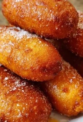 Homemade sourdough corn dogs freshly cooked and served on a plate.