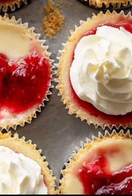 Homemade strawberry cheesecake cupcakes topped with fresh strawberries
