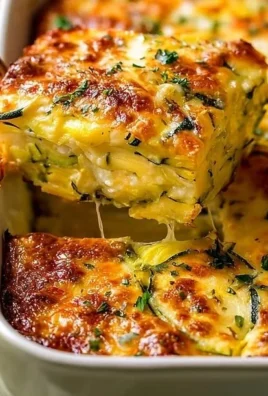 Delicious homemade yellow squash and zucchini casserole in a baking dish.