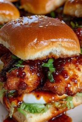 Jimmy's Bang Bang Chicken Sliders served on a platter with garnishes.