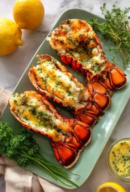 Juicy grilled lobster tails with herb garlic butter on a grill plate