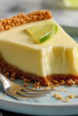 Delicious slice of Key Lime Pie on a plate with a slice of lime garnish