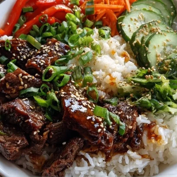 Korean BBQ Steak Rice Bowl with vegetables and rice on a plate