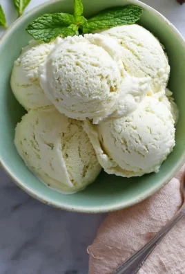 Mint Julep Ice Cream served in a bowl with a sprig of fresh mint