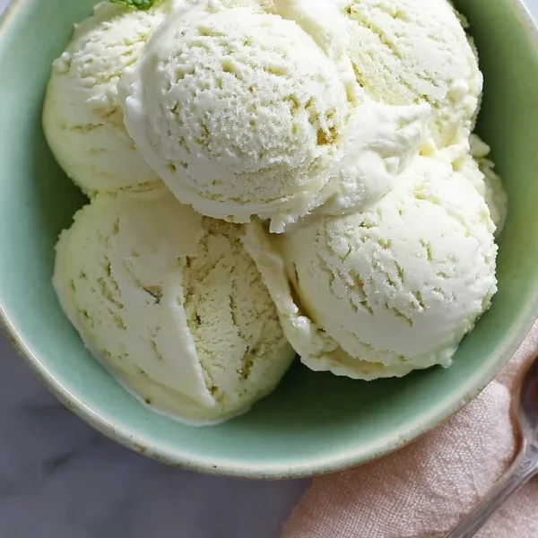 Mint Julep Ice Cream served in a bowl with a sprig of fresh mint