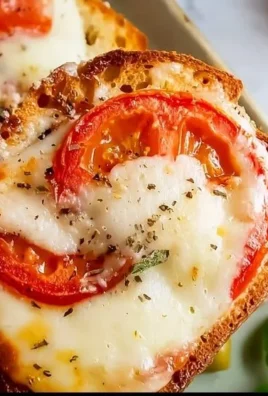 Open faced tomato mozzarella sandwich with fresh ingredients and herbs
