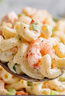 A vibrant shrimp pasta salad featuring juicy shrimp, colorful vegetables, and creamy dressing.