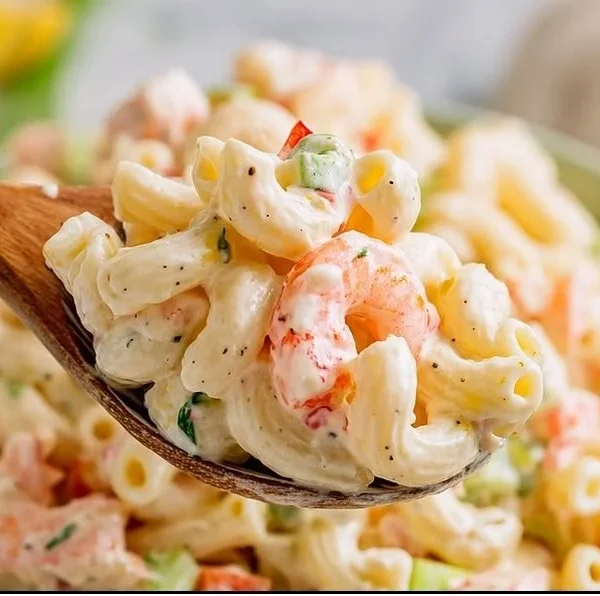 A vibrant shrimp pasta salad featuring juicy shrimp, colorful vegetables, and creamy dressing.