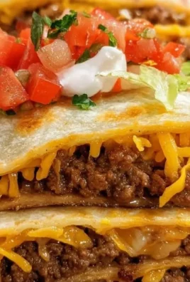 Baked sheet pan tacos with colorful toppings and melted cheese.