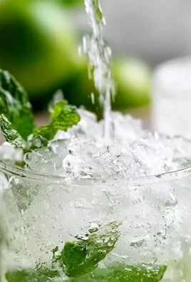 A refreshing Gin Mint Julep served in a glass with mint leaves and ice.