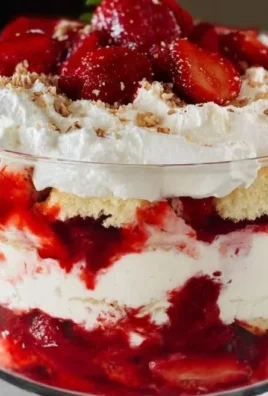A bowl of Strawberry Angel Fluff dessert topped with fresh strawberries