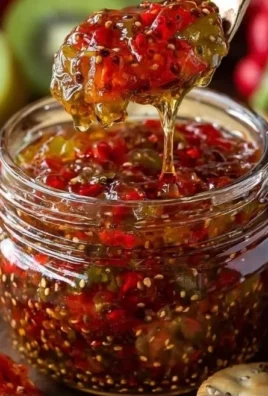 Jar of sugar-free pepper jam on a wooden table