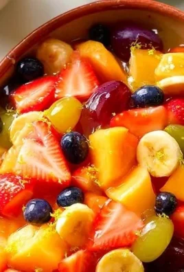 Sweet vanilla pudding fruit salad with fresh fruits in a bowl