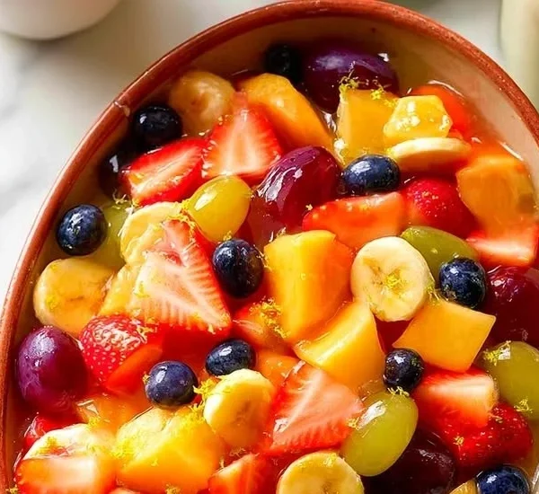 Sweet vanilla pudding fruit salad with fresh fruits in a bowl